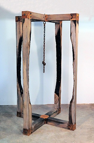 Sculpture created out of rough hewn tulip poplar wood and steel