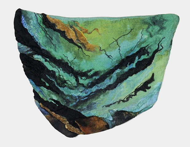 handmade felt wall piece made of dyed, unspun wool  by Sharron Parker. An abstract piece inspired by rocks, wind and water.