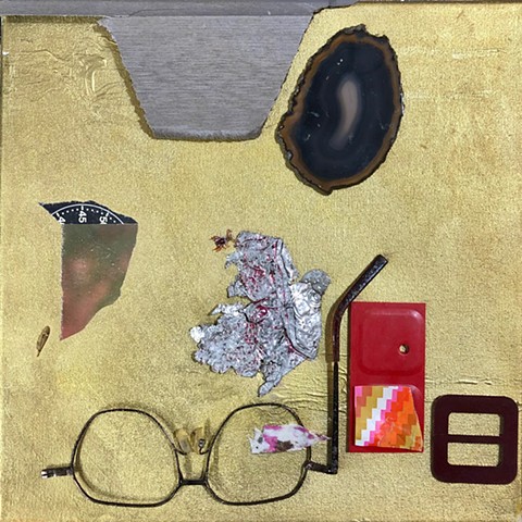 A found object abstract placing (or abstract arrangement) using various objects in a Rauschenberg like way to create a combine or found object collage