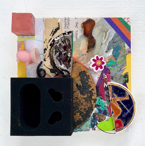 An abstract found object collage painting with black, pink, and metal