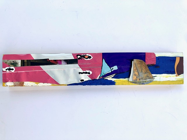An abstract boat in the ocean painting collage, this piece also functions as a sculpture as it is 3D and uses various color elements (pink, blue, white) to create a seascape