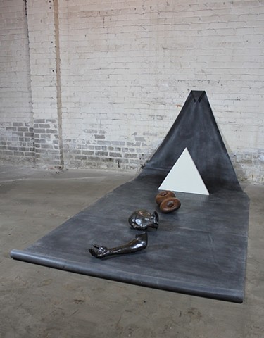 installation + death mask + cast iron arm with wood+ roll of rubber