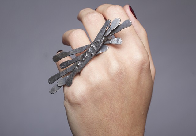 a one-of-a-kind ring composed of forged steel wire and sterling silver