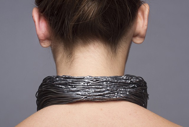 A sculptural one-of-a-kind forged wire neckpiece that is composed of welded steel