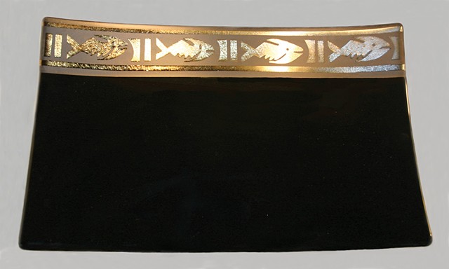 Bullseye black glass with border of gold irid over black, design carved and sandblasted