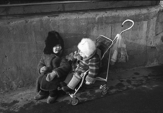 A child and a baby on the street 