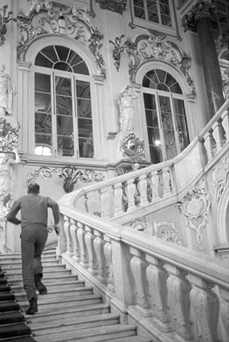 Docent running up the steps in the Hermitage