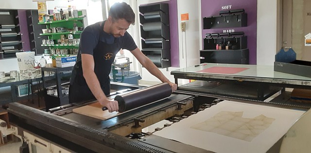 Myles Calvert printing a woodblock for me