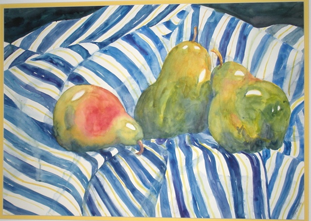 green pears resting on blue & white striped cloth
