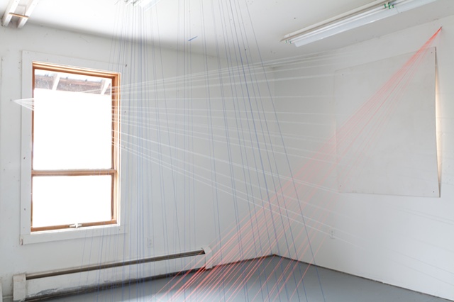 Neon-orange thread traces the sunlight as it entered the space, while the white and blue thread maps the mist and rain outside the window.