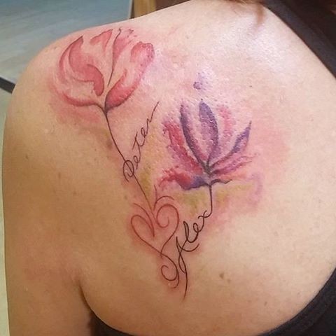 Delicate floral watercolor tattoo