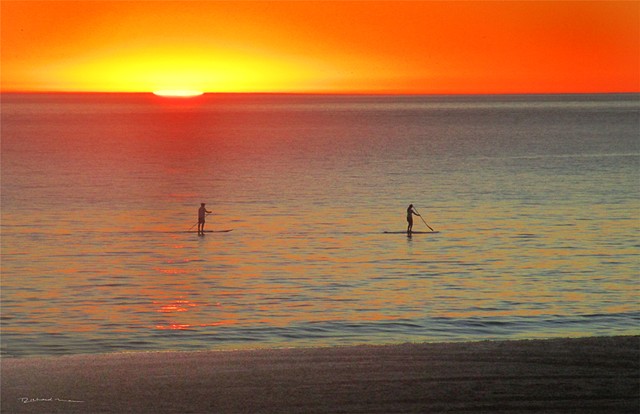 Stand up Paddleboarding  Malibu Beach Ca. Sunset in the Pacific Ocean 