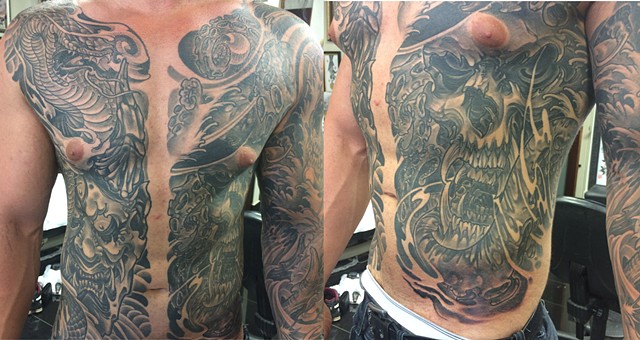 black and grey skull torso tattoo