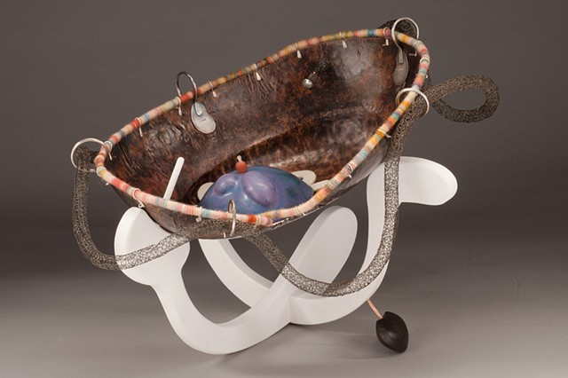 Hand formed copper with fabricated silver elements and enamel coloration. Hand constructed wood and wool components in conjunction with the metal forms.