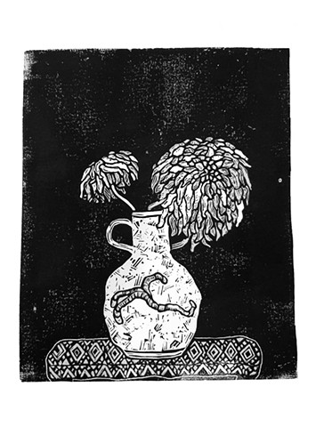 Dying dahlias in earthworm vase 