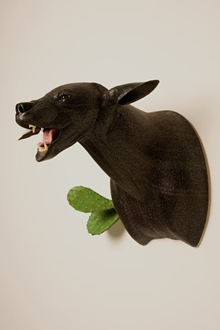 black sparkle vicious bear with nopale cactus growing on him. open mouth