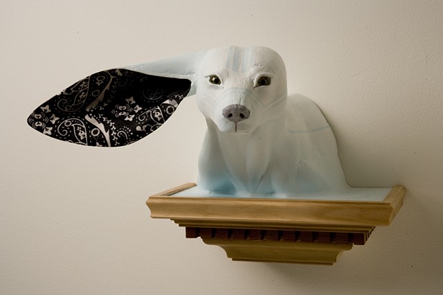 ice white wolverine sculpture with only one black paisley bandana apolstered ear