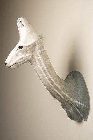 Small deer sculpture with foot growing on head. Inspired by low riders.