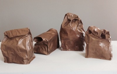 a realistic trompe l'oeil of paper lunch bags,in bronze, having a conversation. by Laura Evans