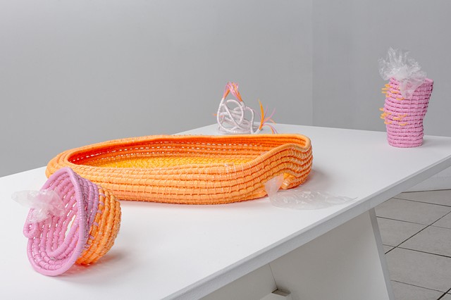 plastic basketry sculpture on a white pedestel by Jose Santiago Perez on view at Ignition Project Space