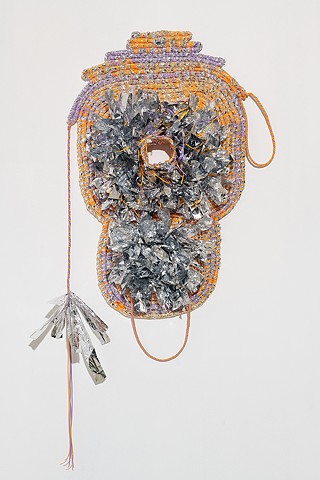 wall based abstract coiled basket made with emergency blankets and tangerine and lavender plastic lacing by José Santiago Pérez
