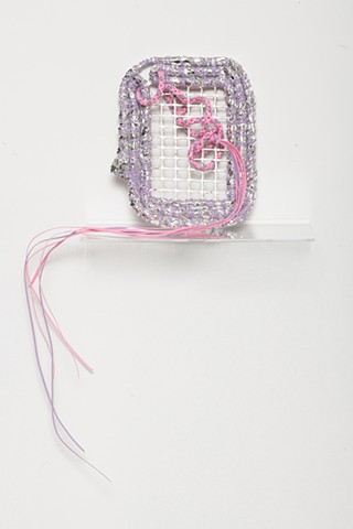 coiled sculpture in silver mylar with lavender and pink plastic lacing, silver leaf, and plastic mesh by José Santiago Pérez