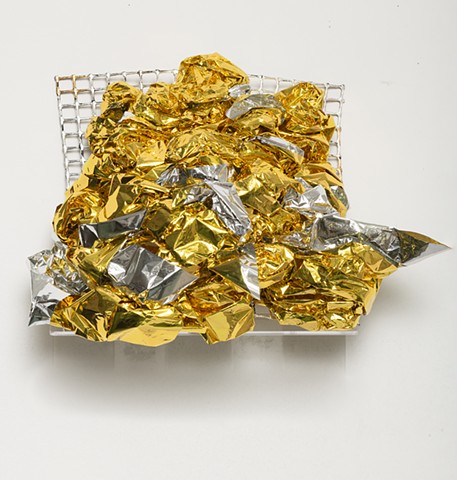 sculpture made with woven silver and gold emergency blankets, plastic mesh, and silver and gold leaf by José Santiago Pérez