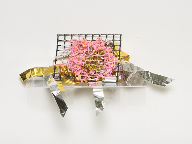 sculpture made with knotted gold and silver mylar emergency blankets, plastic mesh, silver and gold leaf, netted pink plastic lacing, and tangerine plastic beads by José Santiago Pérez