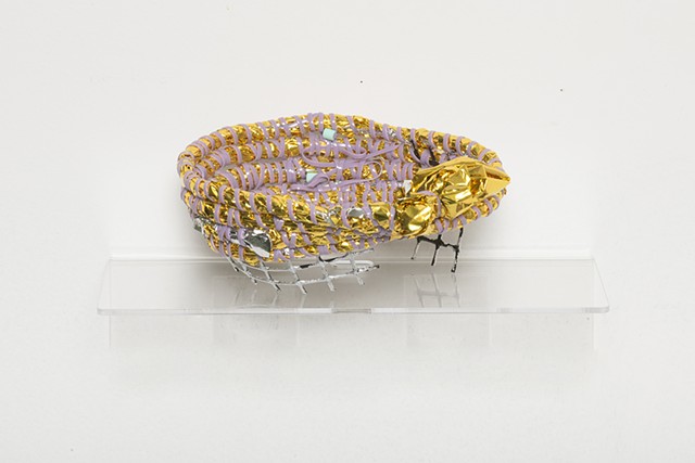 coiled sculpture in gold mylar emergency blankets, lavender plastic lacing, mint plastic beads, plastic mesh, and silver leaf by José Santiago Pérez