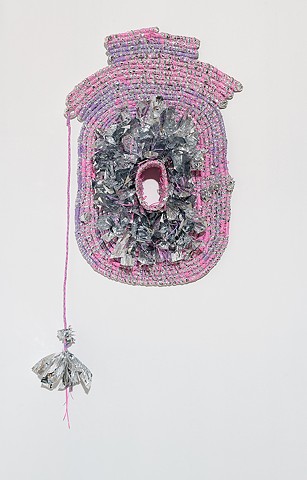 wall based abstract coiled basket made with emergency blankets and pink and lavender plastic lacing by José Santiago Pérez