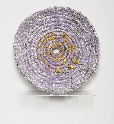 coiled sculpture in silver and gold mylar with lavender plastic lacing by José Santiago Pérez