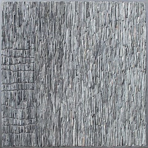 Slate mosaic expressing geological forces in the form of igneous intrusions.