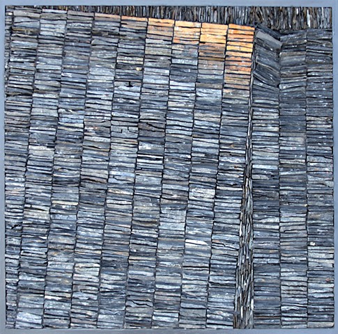 Slate mosaic expressing tectonic forces in a geological context.
