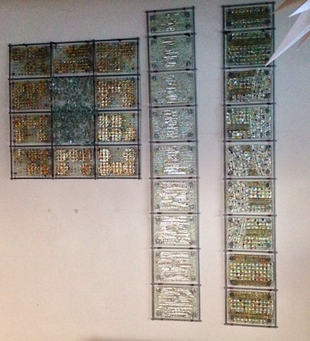fused glass, mica, wire, and bead panels arranged in grids