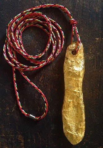 gold bone pendant - red cord