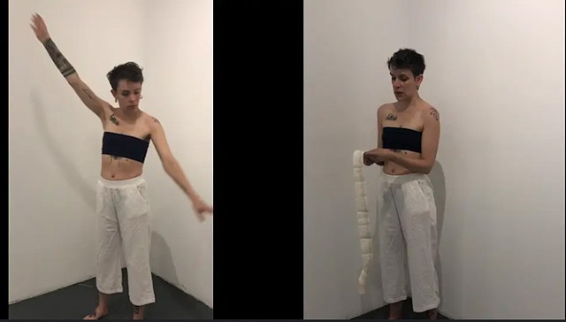 Two video still images of a dancer are side by side with a black strip down the middle. The dancer has short cropped hair, wears a black tube top and long white pants. She is barefoot. In the image on the left she raises her arm above her head and out wid