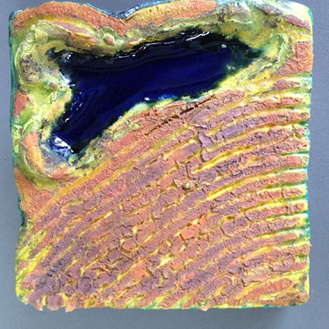 Handbuilt ceramic tiles for wall display. Aerial view.  Slice of land.