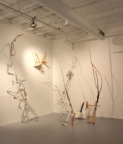 sculptural installation made of found furniture, tree limbs, jute, cotton yarn, gesso, paint, PVC
