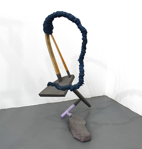 sculpture created with found furniture, jute, paint, concrete; title is Surge Protector