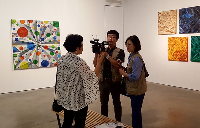 Artist Chun Hui Pak being interviewed.