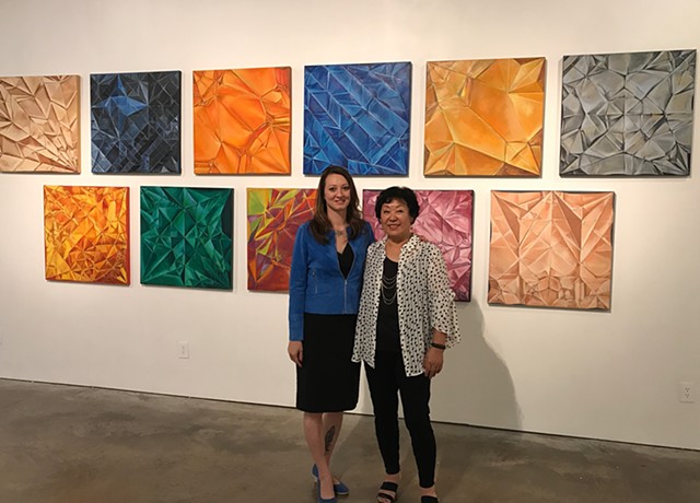 Left to right - Gallery owner Cindy Lisica and Artist Chun Hui Pak along with artist origami interpretations of Chinese Zodiac.  