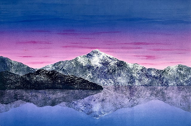 Mountains and island reflected in still water, violet pink sky
