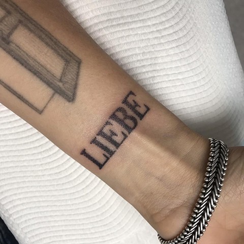 Tattoo by Amy 'Unalome' Jones. Hand-poke tattoo 'LIEBE' lettering. La Flor Sagrada Tattoo Studio. Melbourne, Australia
