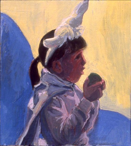 a young girl in a unicorn costume with a horn sitting on a blue couch eating a green apple
