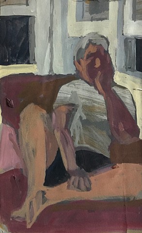 A figure seated on a couch, with hand resting on face.