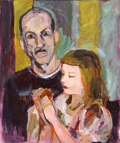 A child sits on a man's lap, intently looking at a bagel