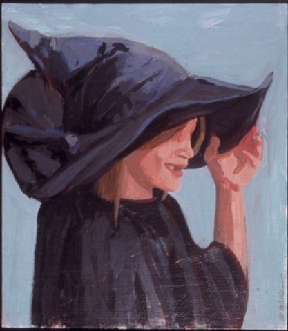 a child in a witch costume with a large witch hat