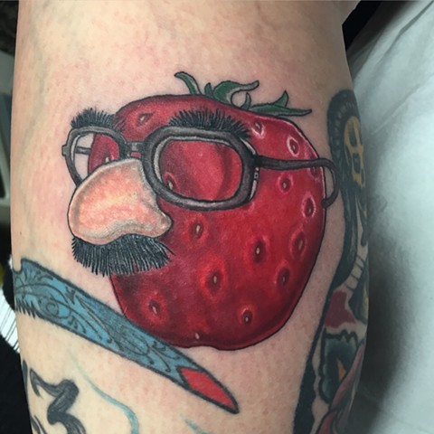Strawberry disguised with nose and glasses. 