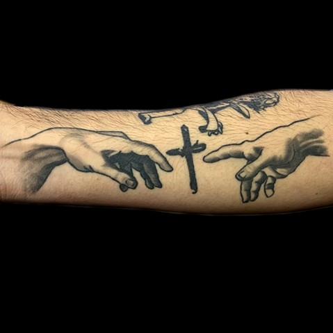Black and grey reproduction of the hands in creation of Adam.