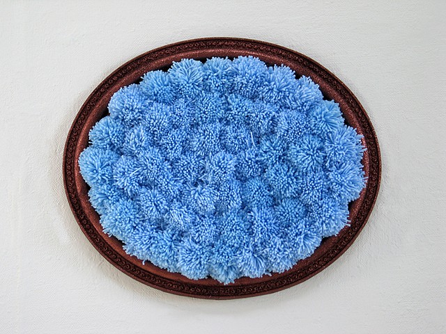 sculpture found oval picture frame painted glitter brown with sky blue yarn pom poms by Holly Campbell